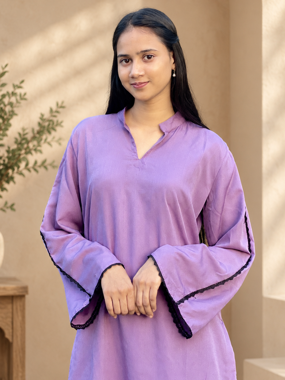 Lavender Royale Pakistani Suit Woman wearing a lavender Pakistani suit with black lace detailing