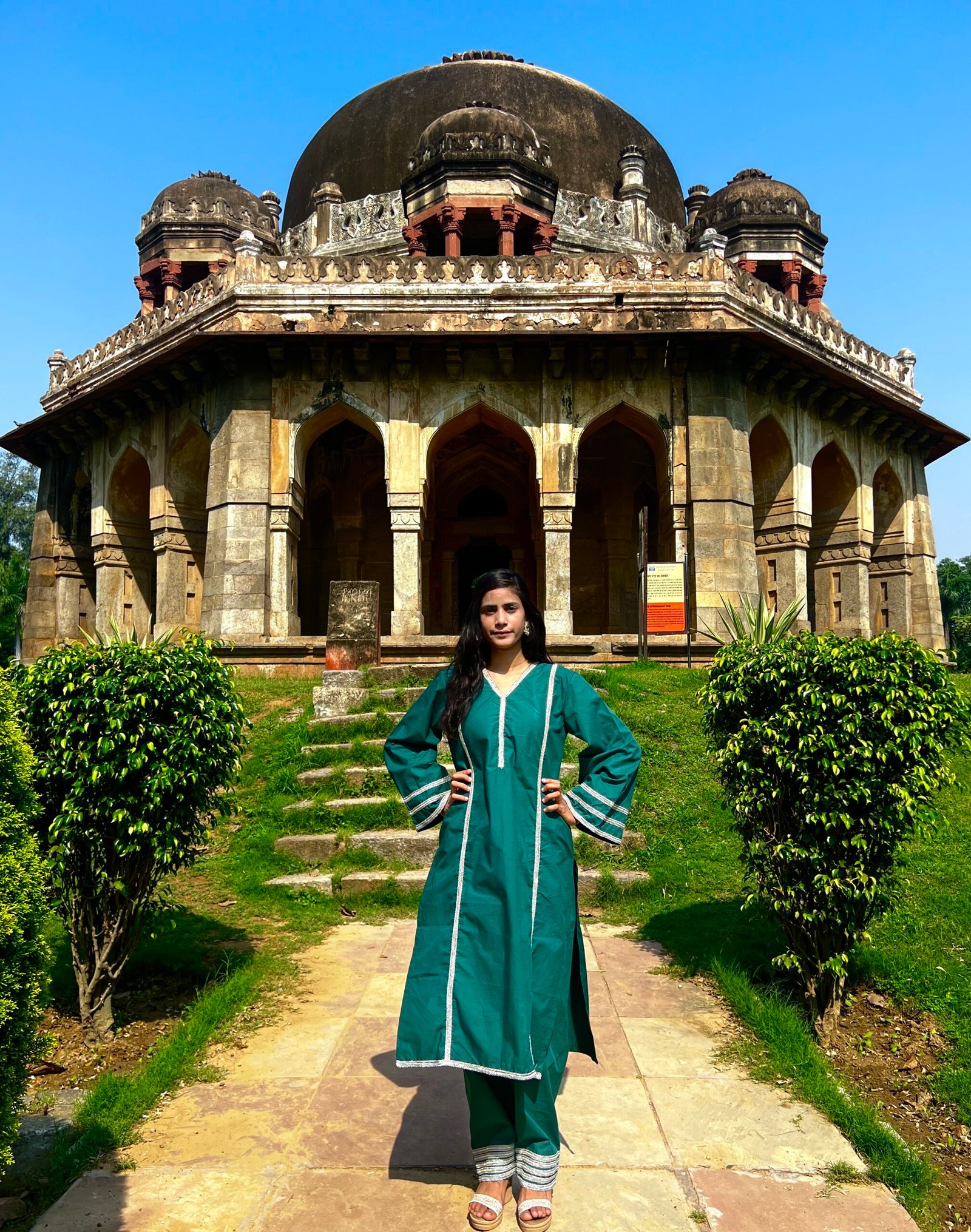 Teal Green Kurta Set with Matching Pants – Full Length Woman wearing a teal green kurta set with matching pants and rainbow silver lace detailing in front of a historic monument